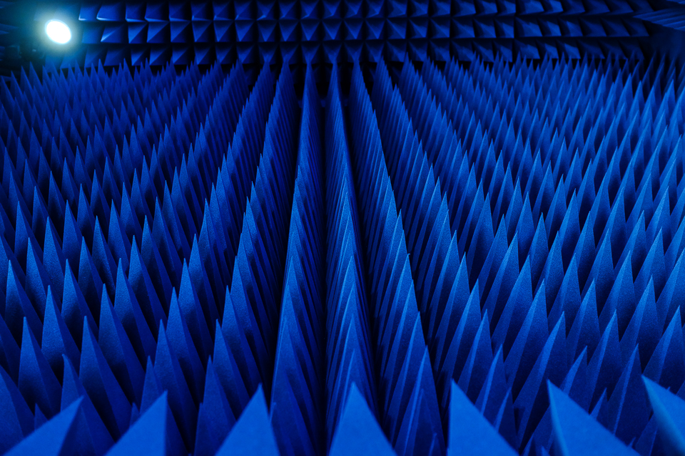 Pyramidal foam wedges of an anechoic chamber lit in deep blue
